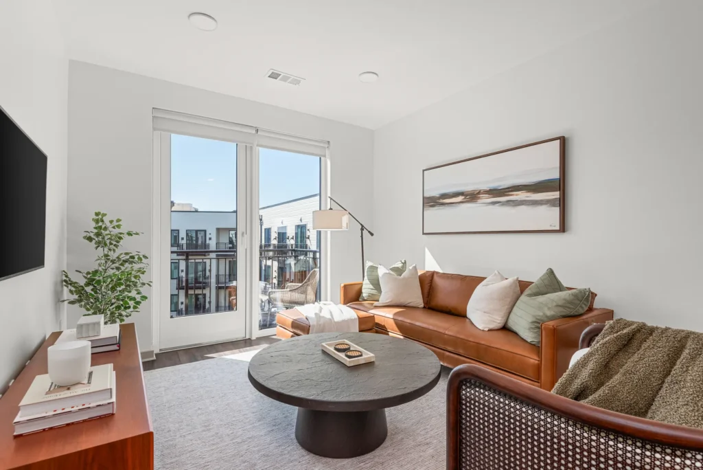 Modern apartment living room with private balcony at 445 Park Commons Nashville