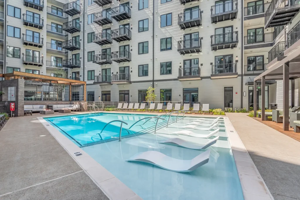 Saltwater pool with sun shelf loungers at 445 Park Commons apartments in Nashville